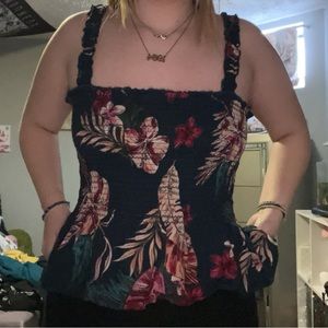 Navy color with Hawaiian flowers, skirt like bottom on the shirt